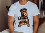 Rottweiler with snack bag and text "Fueled by Loyalty & Snacks" on t-shirt.