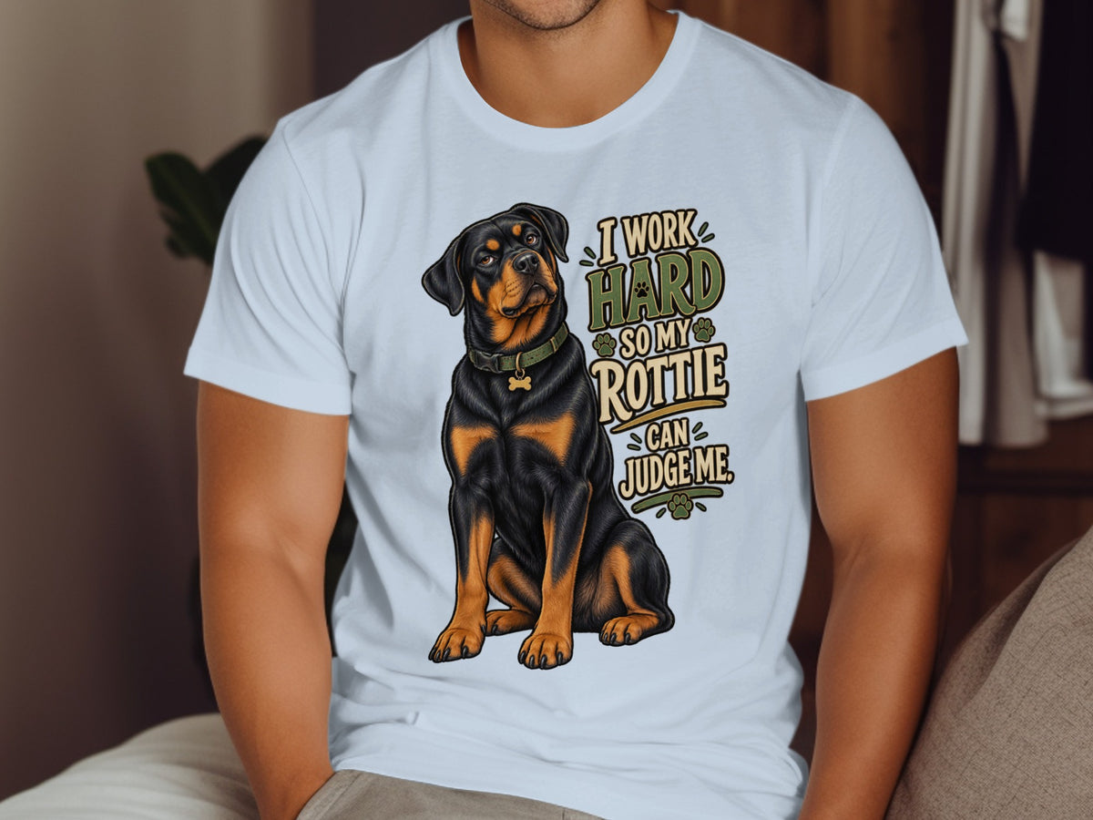 White t-shirt with a Rottweiler illustration and text: "I work hard so my Rottie can judge me."