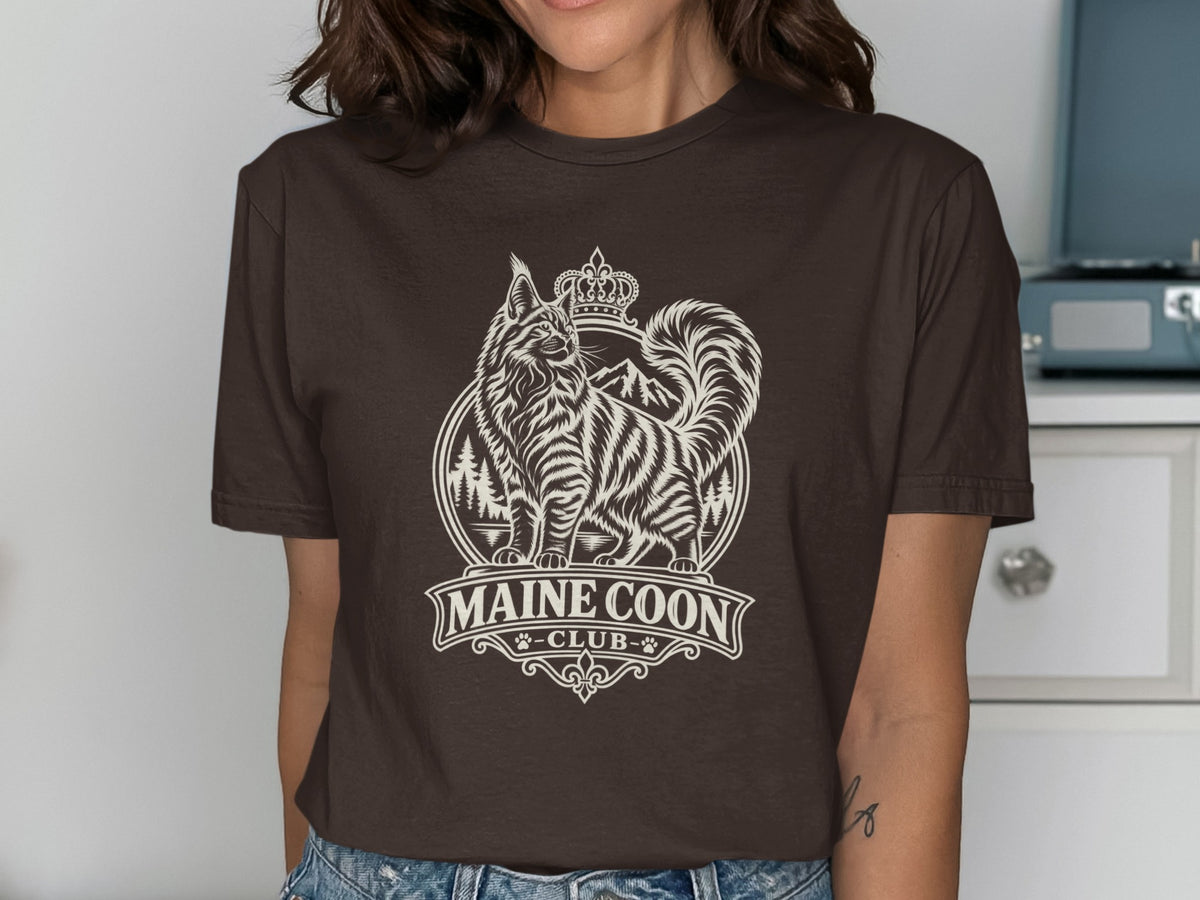 Brown t-shirt with a white graphic of a Maine Coon cat, crown, and text "MAINE COON -CLUB-".
