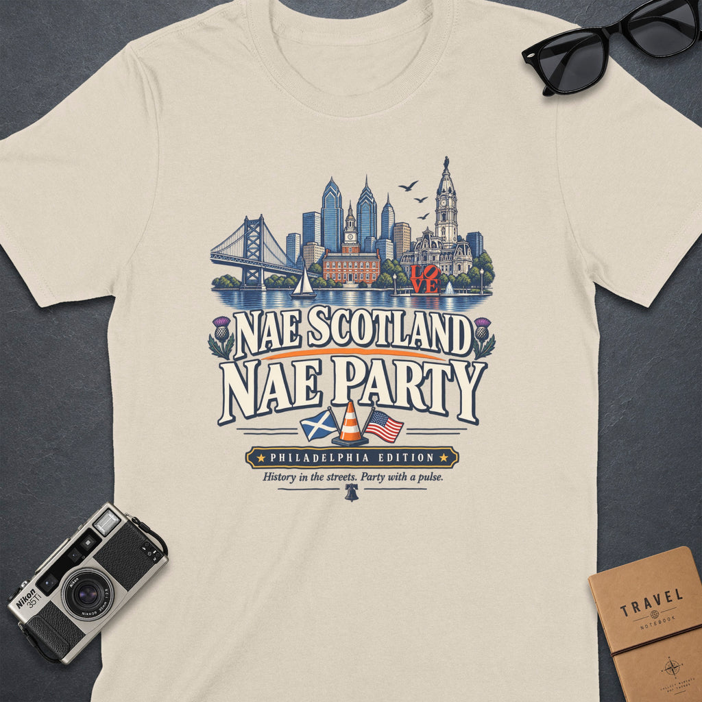 Cream t-shirt with "Nae Scotland Nae Party Philadelphia Edition" text and skyline graphic.
