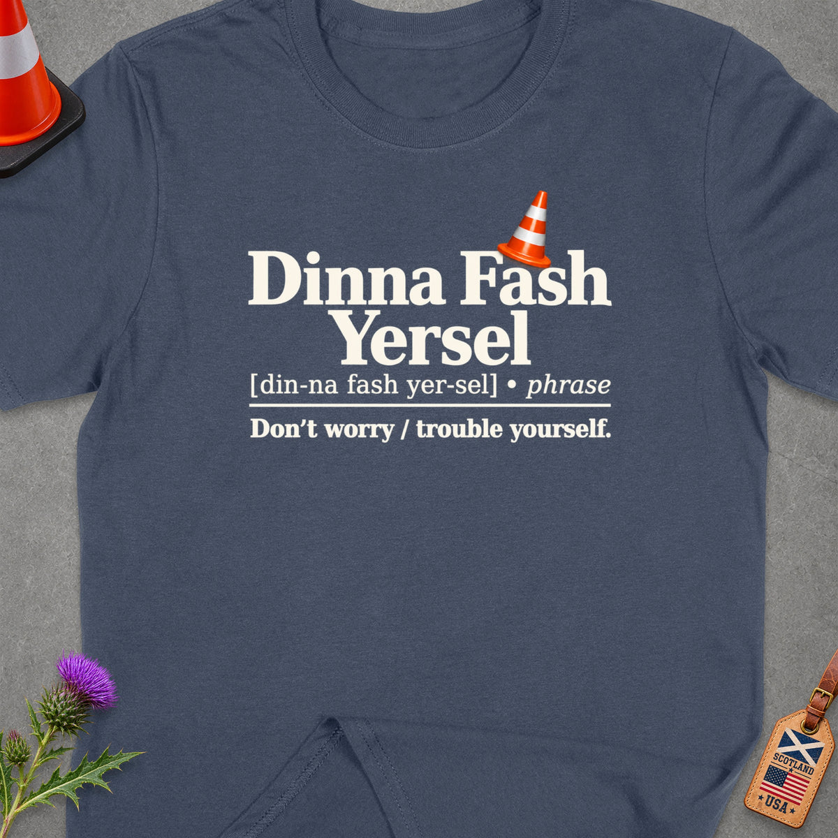 T-shirt with "Dinna Fash Yersel" and its meaning in English, plus flags.
