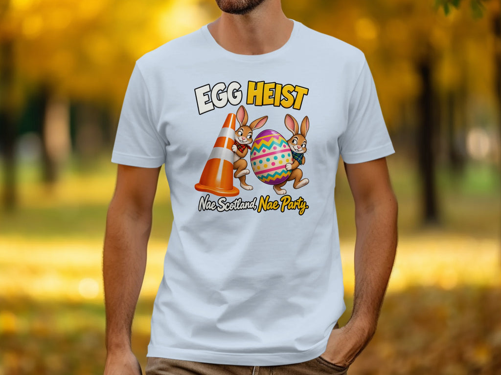 White t-shirt graphic with "Egg Heist" and bunnies, one holding a cone, one an egg.