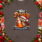 Hedgehog wearing Santa hat holding traffic cone with text "Wee Prickly, Nae Scotland, Nae Party."