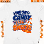 White t-shirt with graphic "You say candy, I say sweets" and traffic cone.