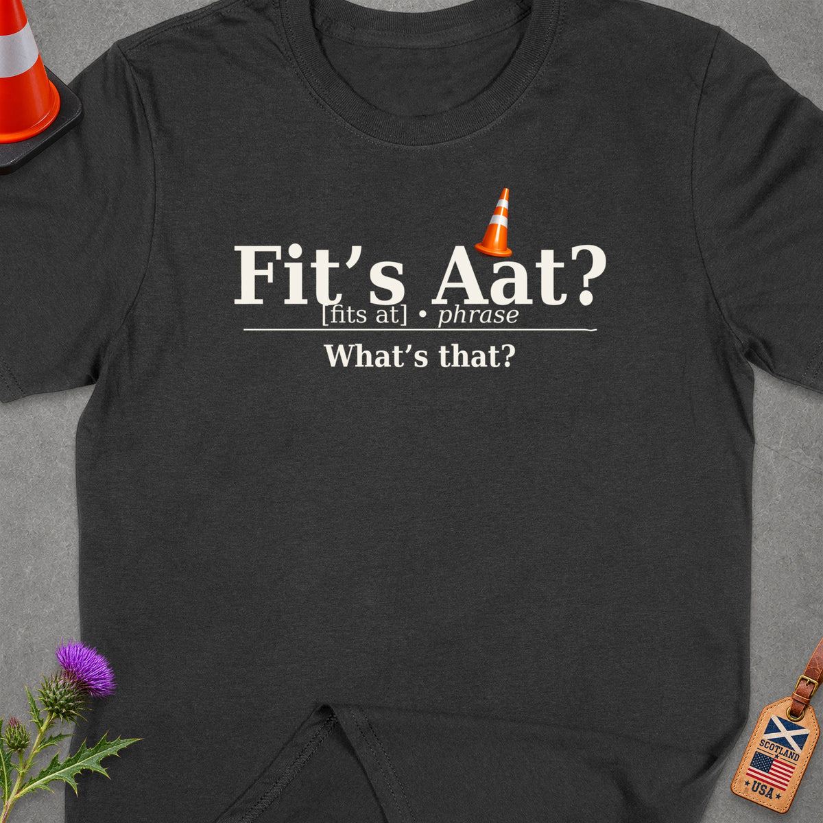 Dark grey t-shirt with "Fit's Aat? What's that?" text and Scottish-American flag tag.