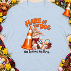Cartoon rabbit leaning on traffic cone with coffee, text says "Hare of the Dog."