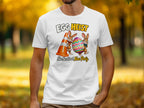 White t-shirt with cartoon bunnies, traffic cone, and "Egg Heist" text.