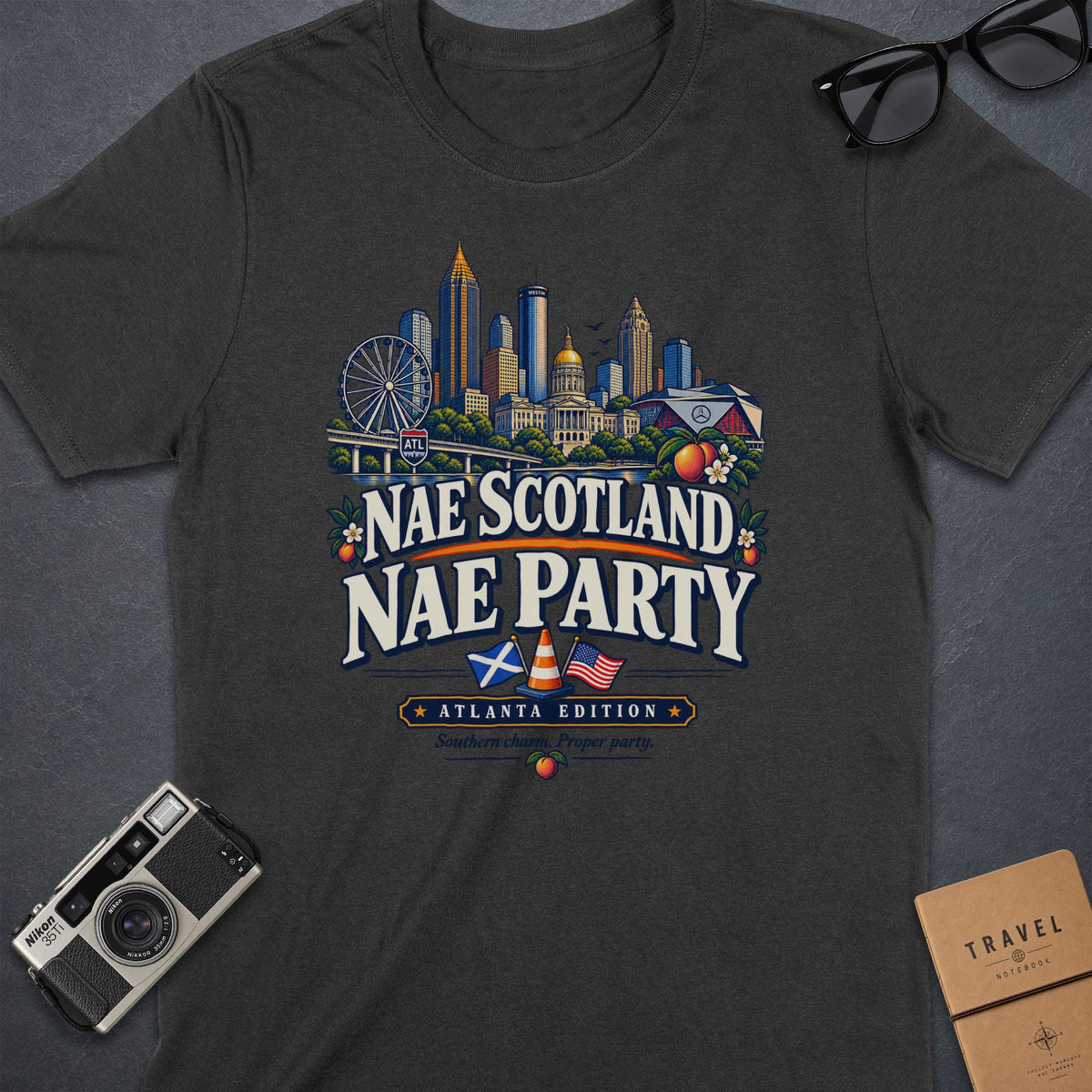 Dark gray t-shirt with Atlanta skyline graphic and "Nae Scotland Nae Party" text.