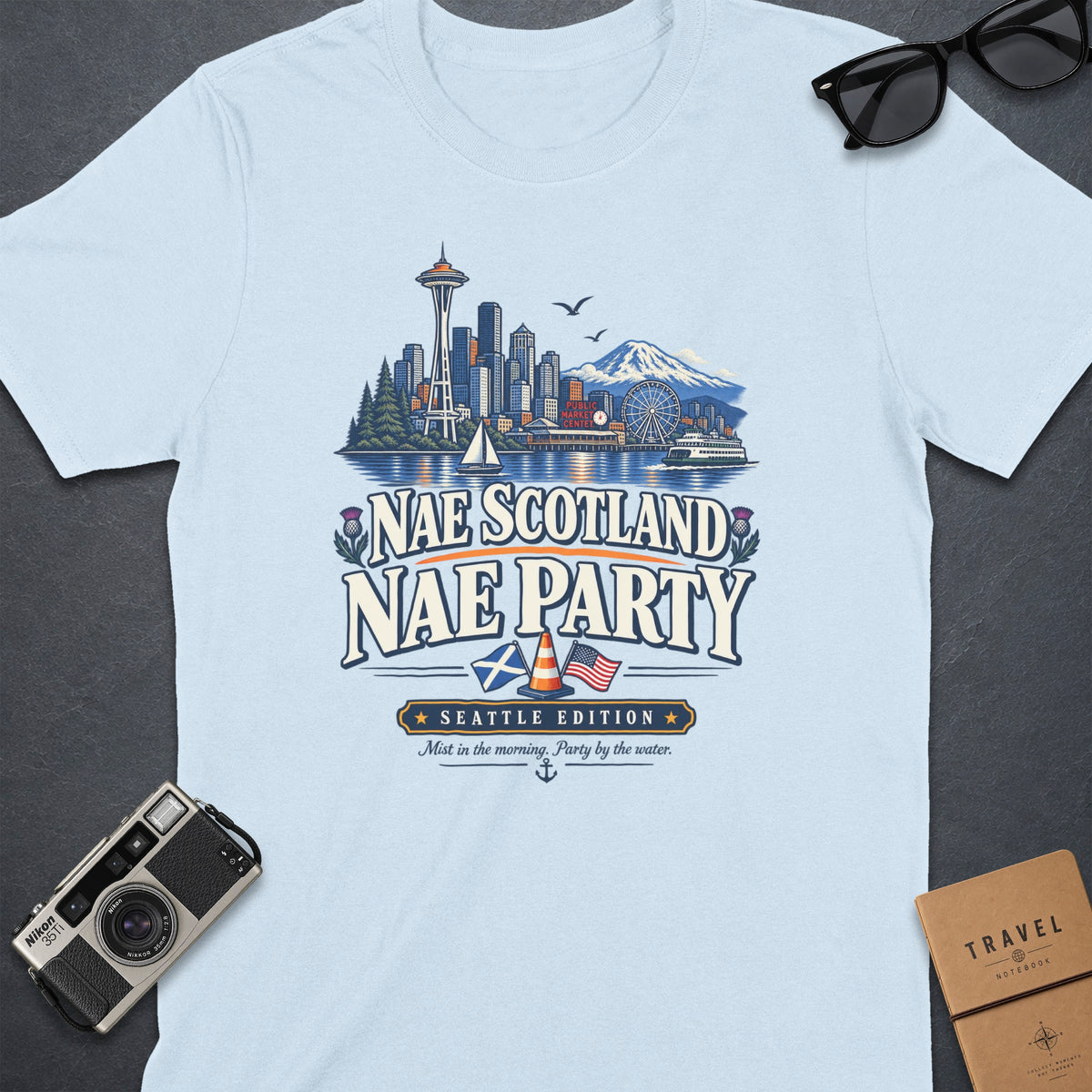 Light blue t-shirt with Seattle skyline graphic and "Nae Scotland Nae Party" text.