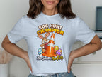 T-shirt with cartoon rabbit holding traffic cone and text "EGG HUNT CHAMPION".
