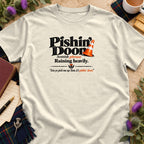Off-white t-shirt featuring black and orange text that reads Pishin Doon with a traffic cone.