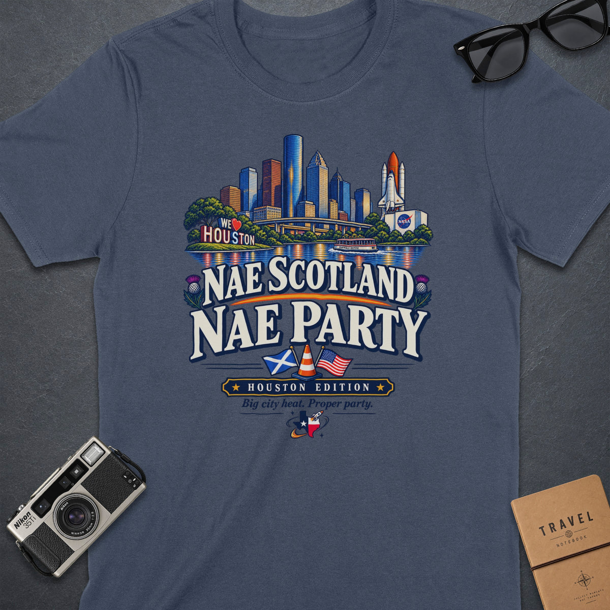 Navy t-shirt with graphic: Houston skyline, NASA shuttle, "Nae Scotland Nae Party" text.