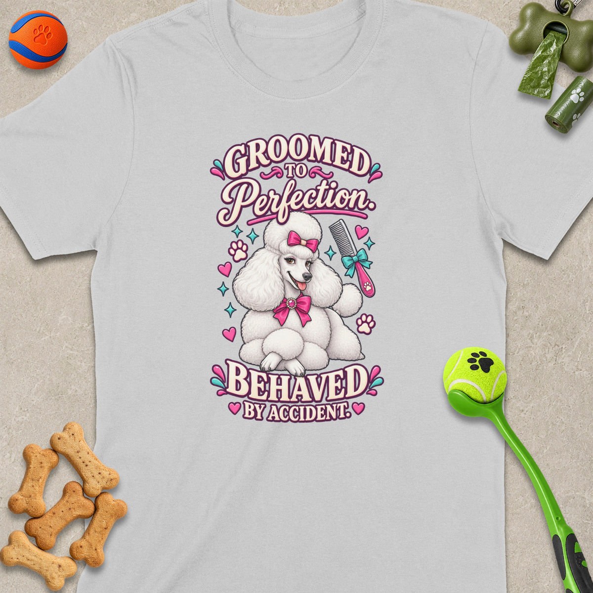 White t-shirt with a poodle graphic that says "Groomed to Perfection."