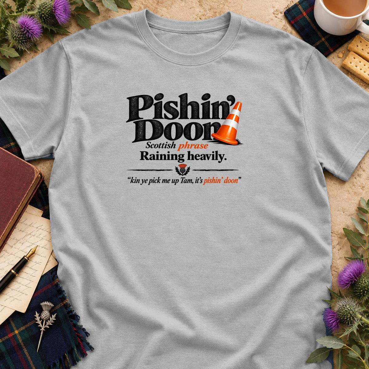 Light gray t-shirt with black text that reads "Pishin' Doon" and an orange traffic cone.