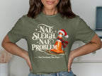 Green t-shirt with text "Nae Sleigh. Nae Problem." and a traffic cone on a sled.