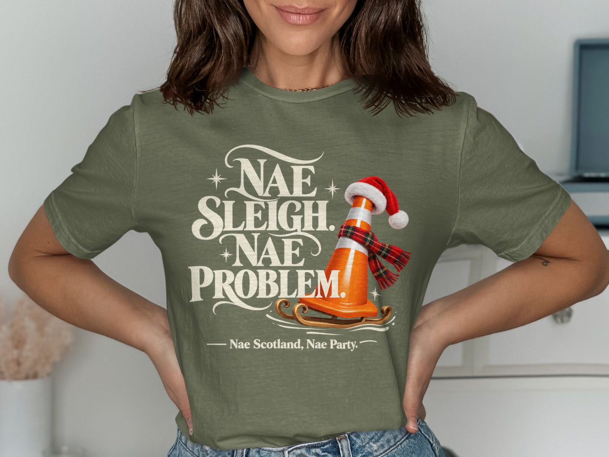 Green t-shirt with text "Nae Sleigh. Nae Problem." and a traffic cone on a sled.