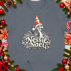 Nessie Noel graphic with text "Nae Scotland, Nae Party." on a grey t-shirt.